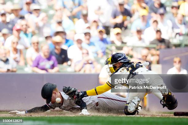 Pavin Smith of the Arizona Diamondbacks scores a run against William Contreras of the Milwaukee Brewers in the sixth inning at American Family Field...