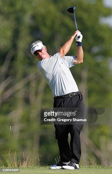 John Harris watches his tee shot on the ninth hole during the first round of the 2012 Senior United States Open at Indianwood Golf and Country Club...