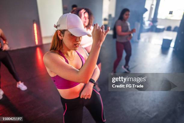 young woman in a dancing class at a dance studio - zumba stockfoto's en -beelden