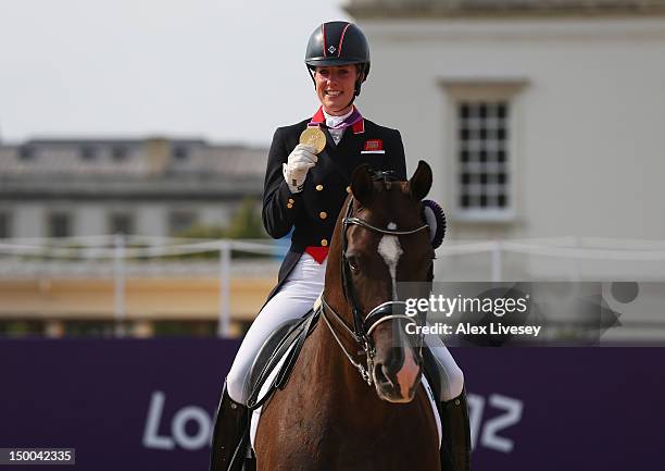 Charlotte Dujardin of Great Britain riding Valegro celebrates with her gold medal during the medal ceremony following the Individual Dressage on Day...