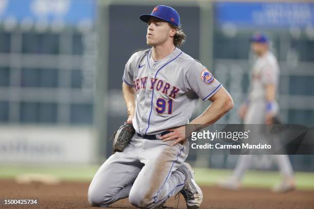 Josh Walker of the New York Mets exits the game during the seventh inning after being injured on a play against the Houston Astros at Minute Maid...