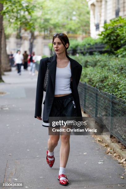 Guest wears black blazer, skirt outside Rhude during the Menswear Spring/Summer 2024 as part of Paris Fashion Week on June 21, 2023 in Paris, France.