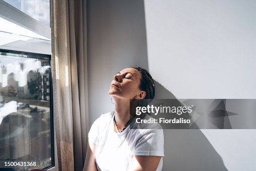 Portrait of a woman sitting by the window Portrait of a woman sitting by the window
