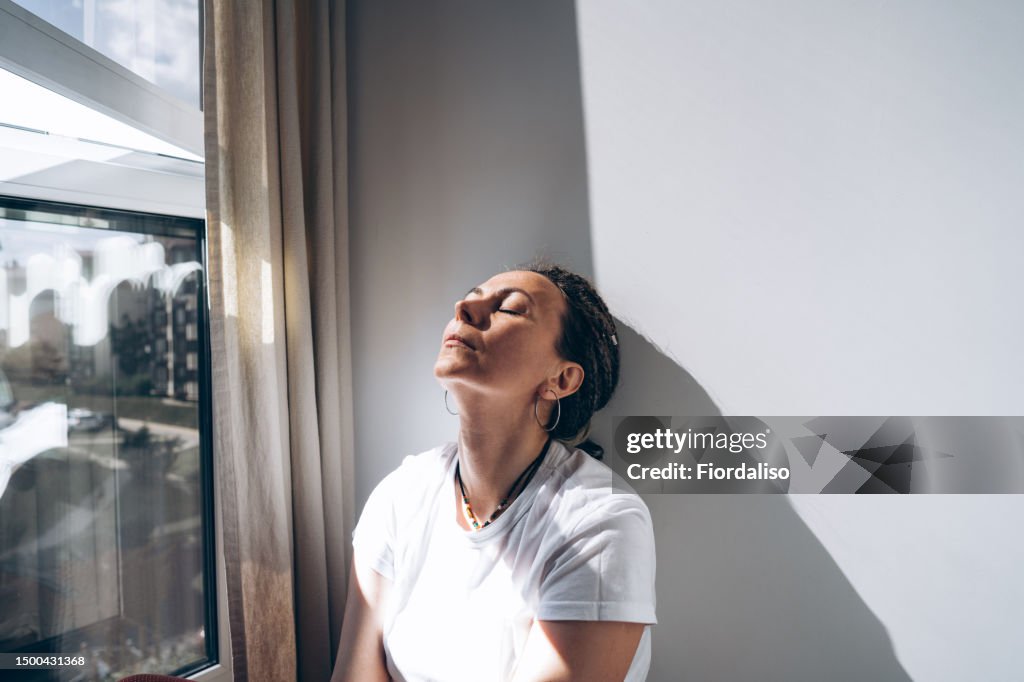 Portrait of a woman sitting by the window