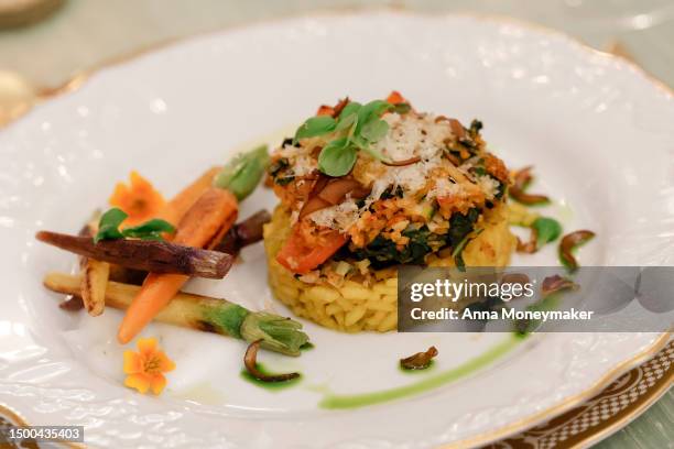 The main course that will be served, stuffed portobello mushrooms and creamy saffron-infused risotto, is displayed at a media preview of the state...