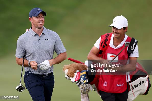 Rory McIlroy of Northern Ireland and caddy Harry Diamond walk to the ...