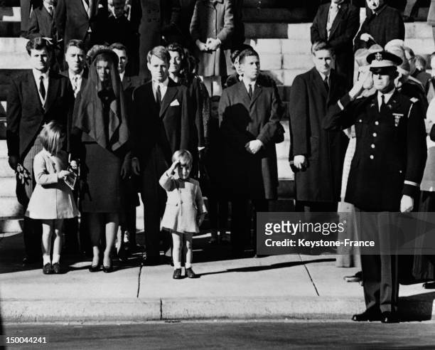 Outside Cathedral St Matthew John John Kennedy salutes his father's coffin with members of the Kennedy family From left: Senator Edward Kennedy,...