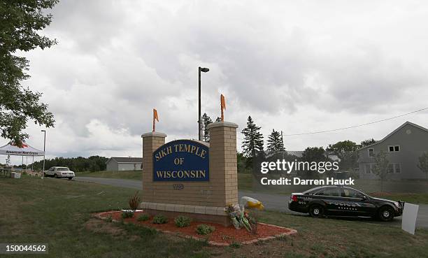 Bouquets of flowers are left at the entrance to the Sikh Temple of Wisconsin August 9, 2012 in Oak Creek, Wisconsin. Suspected gunman, 40-year-old...