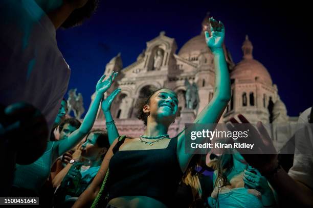 Parisians dance in front of Sacré-Coeur Basilica in Montmartre in a free dance concert, part of Fête de la Musique, on June 21, 2023 in Paris,...