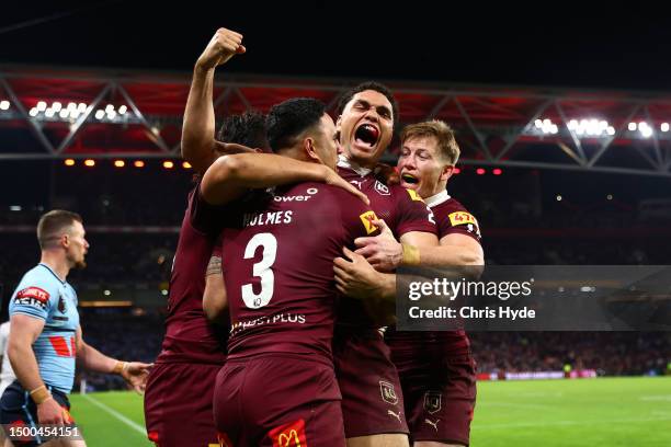 Xavier Coates of the Maroons celebrates with try-scorer Valentine Holmes during game two of the State of Origin series between the Queensland Maroons...