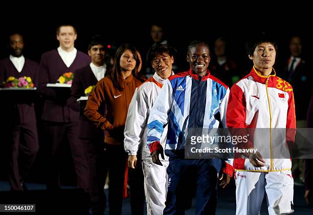Silver medalist Cancan Ren of China, gold medalist Nicola Adams of Great Britain, bronze medalist Chungneijang Mery Kom Hmangte of India and bronze...