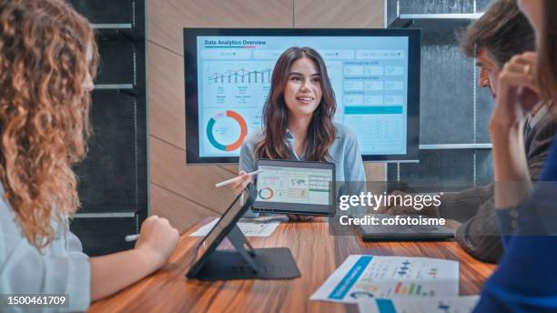 group of business people presenting and brainstorming a modern office meeting room - data analyst stock pictures, royalty-free photos & images