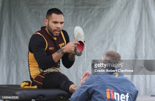 Jarman Impey of the Hawks has his foot strapped during a Hawthorn Hawks AFL training session at Waverley Park on June 22, 2023 in Melbourne,...