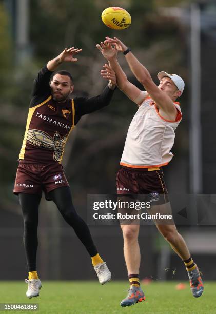 Jarman Impey of the Hawks and Josh Morris of the Hawks compete for the ball during a Hawthorn Hawks AFL training session at Waverley Park on June 22,...