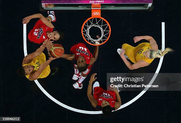 Diana Taurasi, Tamika Catchings and Candace Parker of United States look to control the ball against Liz Cambage and Lauren Jackson of Australia...