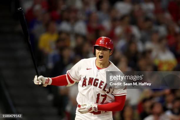 Shohei Ohtani of the Los Angeles Angels reacts after flying out during the ninth inning of a game against the Los Angeles Dodgers at Angel Stadium of...
