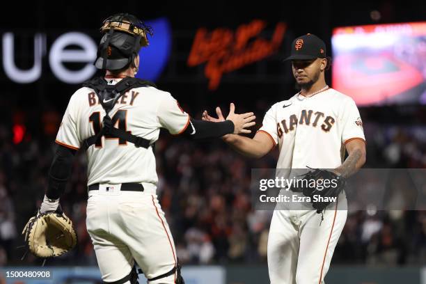 Camilo Doval of the San Francisco Giants is congratulated by Patrick Bailey after they beat the San Diego Padres on June 21, 2023 in San Francisco,...