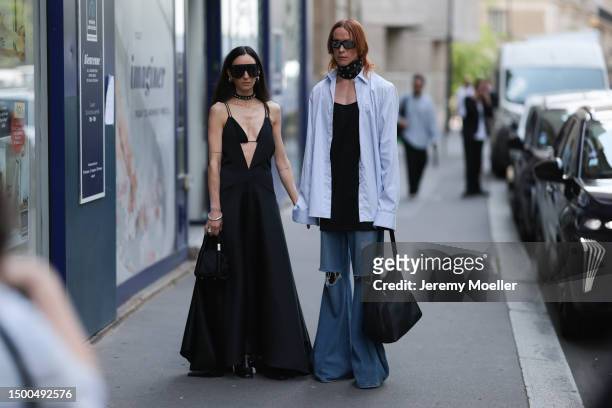Ilenia Toma is seen wearing a black long dress, black statement shades, black mini bag and Simon Nygard is wearing a black leather metal rivets...