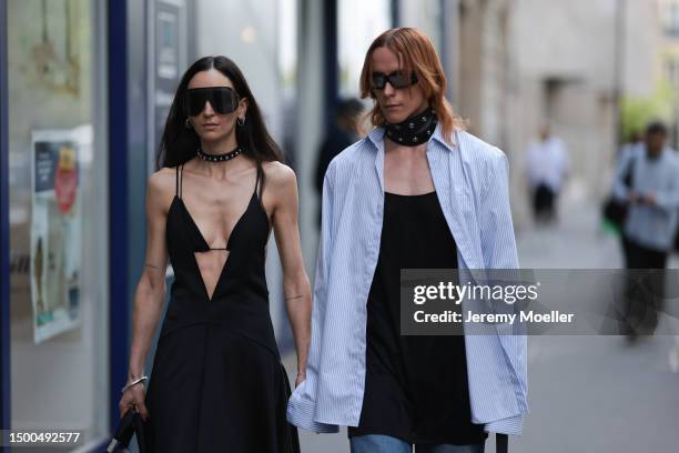 Ilenia Toma is seen wearing a black long dress, black statement shades, black mini bag and Simon Nygard is wearing a black leather metal rivets...