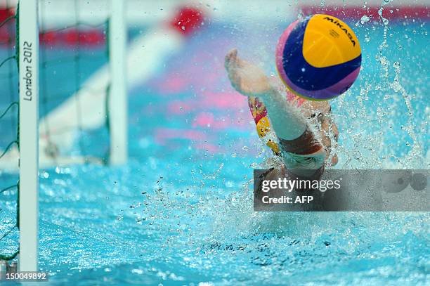 Australia's goalkeeper Victoria Brown dives for the ball as Hungary score against Australia during their women's water polo bronze medal match at the...
