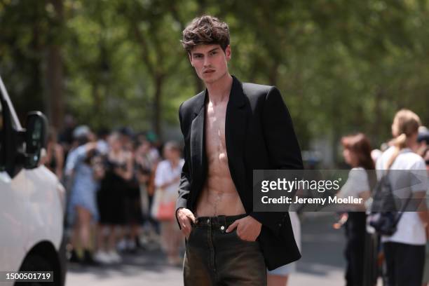 Moritz Hau is seen wearing a black blazer and brown black bootcut jeans outside EGONLAB show during the Menswear Spring/Summer 2024 as part of Paris...