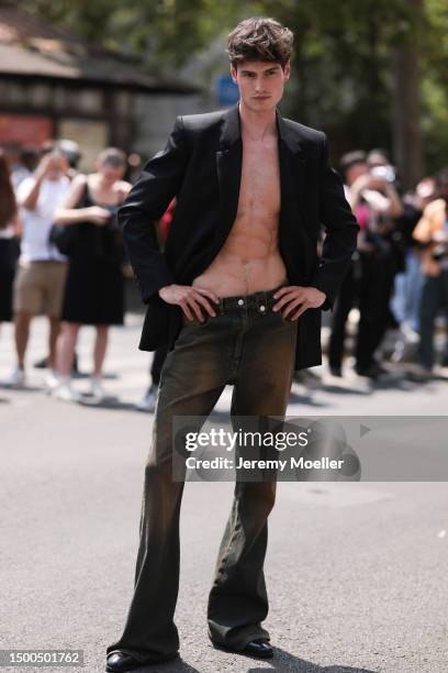 Moritz Hau is seen wearing a black blazer and brown black bootcut jeans outside EGONLAB show during the Menswear Spring/Summer 2024 as part of Paris...