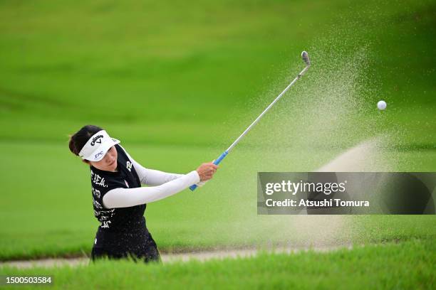 Riko Inoue of Japan hits out from a bunker on the 5th hole during the first round of Earth Mondahmin Cup at Camellia Hills Country Club on June 22,...