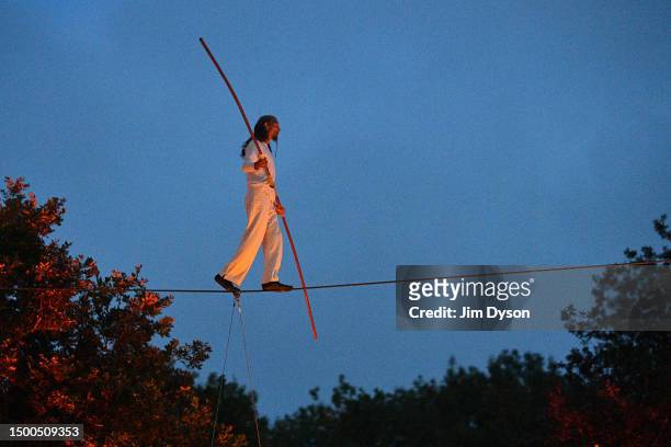 Performer walks a tightrope as part of a peace ritual at the stone circle on Day 1 of Glastonbury Festival 2023 at Worthy Farm, Pilton on June 21,...