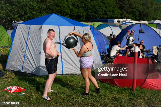 Festival-goers carry out their morning ablutions outside their tents at the start of Day 2 of Glastonbury Festival 2023 on June 22, 2023 in...