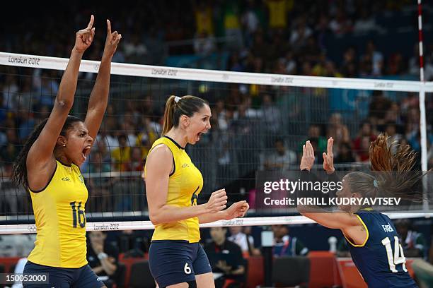 Brazil's Fernanda Rodrigues , Thaisa Menezes and Fabiana Oliveira celebrate winning a point during the Women's semifinal volleyball match between...