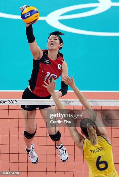 Yukiko Ebata of Japan spikes the ball as Thaisa Menezes of Brazil defends during the Women's Volleyball semifinal match on Day 13 of the London 2012...