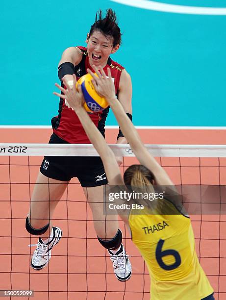 Yukiko Ebata of Japan spikes the ball as Thaisa Menezes of Brazil defends during the Women's Volleyball semifinal match on Day 13 of the London 2012...