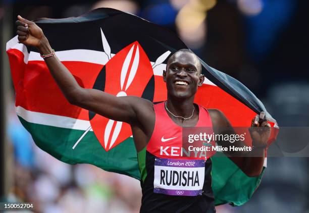 David Lekuta Rudisha of Kenya celebrates with his country's national flag after winning gold and setting a new world record of 1.40.91 in the Men's...