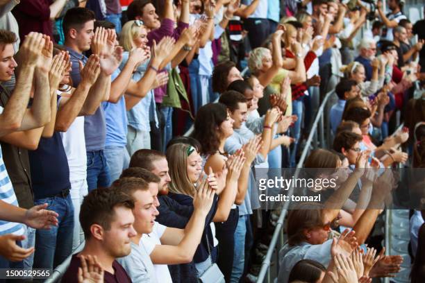 fans on the stadium clapping - politics and government stock pictures, royalty-free photos & images