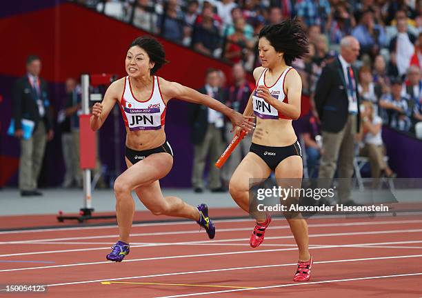 Anna Doi of Japan passes the relay baton to Kana Ichikawa of Japan during the Women's 4 x 100m Relay Round 1 on Day 13 of the London 2012 Olympic...