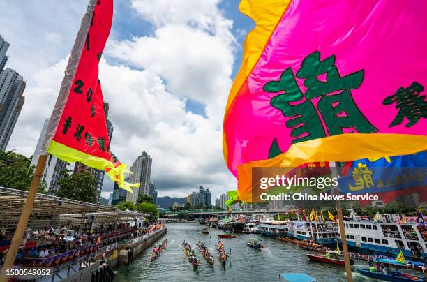 Flags flutter to cheer for rowers competing in 2023 Aberdeen Dragon Boat Race during the Dragon Boat Festival on June 22, 2023 in Hong Kong, China.