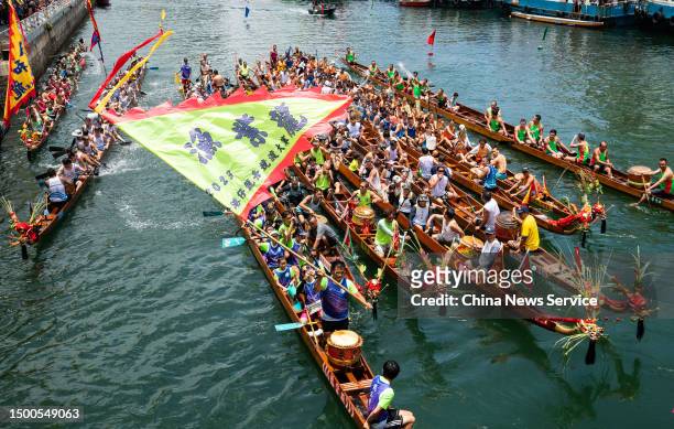 Flags flutter to cheer for rowers competing in 2023 Aberdeen Dragon Boat Race during the Dragon Boat Festival on June 22, 2023 in Hong Kong, China.