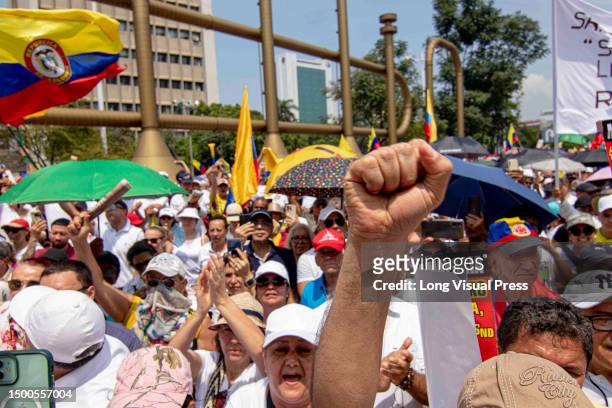 Demonstrators hold signs against Colombian president Gustavo Petro during the anti-government protests against the government and reforms of...
