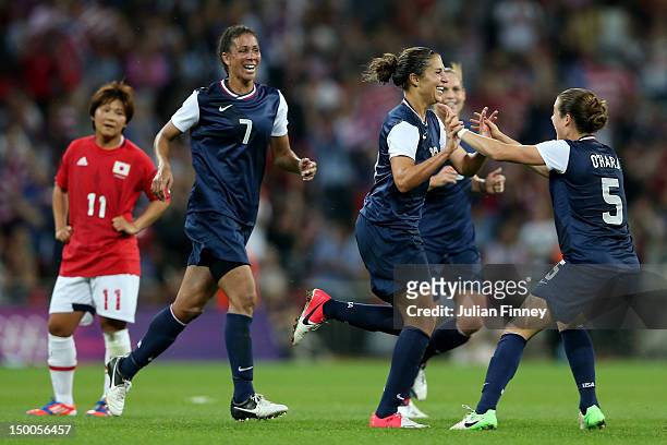Carli Lloyd of United States celebrates with Kelley O'Hara and Shannon Boxx after scoring in the second half against Japan during the Women's...