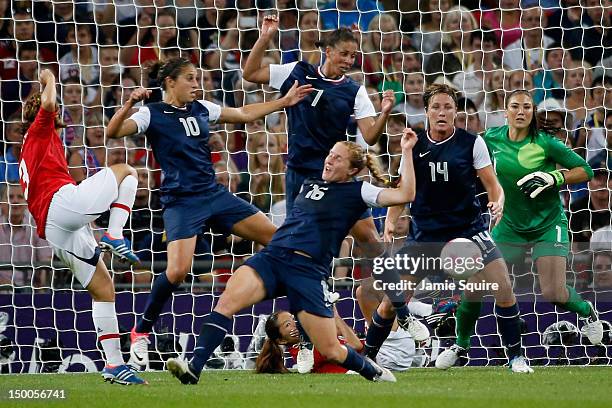 Azusa Iwashimizu of Japan attempts a shot against Carli Lloyd, Shannon Boxx, Rachel Buehler, Abby Wambach, and Hope Solo of the United States during...