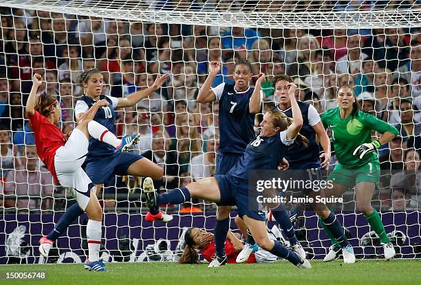 Azusa Iwashimizu of Japan attempts a shot against Carli Lloyd, Shannon Boxx, Rachel Buehler, Abby Wambach, and Hope Solo of the United States during...