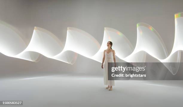 mujer joven frente a senderos de luz blanca - art modeling studios fotografías e imágenes de stock