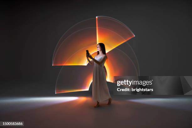 young woman using a smart phone - light trail people stock pictures, royalty-free photos & images