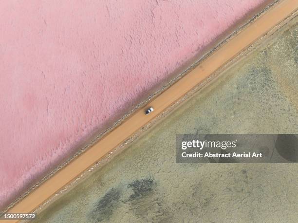 drone photograph looking down on an off-road vehicle driving across lake macdonnell, penong, south australia, australia - side by side comparison stock pictures, royalty-free photos & images