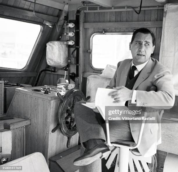 Fiumicino, Italy, May 1964, the actor Alberto Sordi with his sailing boat.