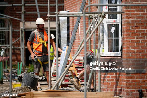 Construction workers build homes on a construction development site on June 22, 2023 in Nantwich, England. The Bank of England has increased the base...
