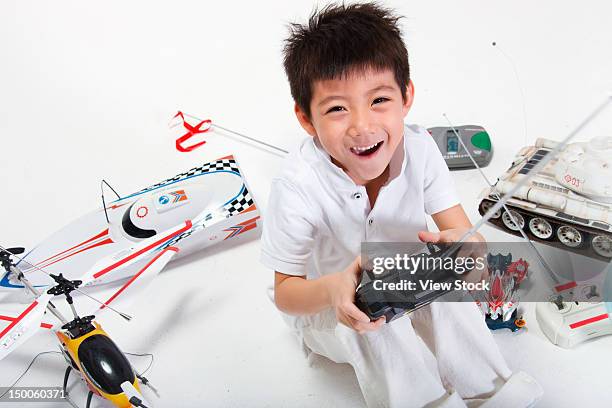 boy playing toys - radio controlled handset stock pictures, royalty-free photos & images