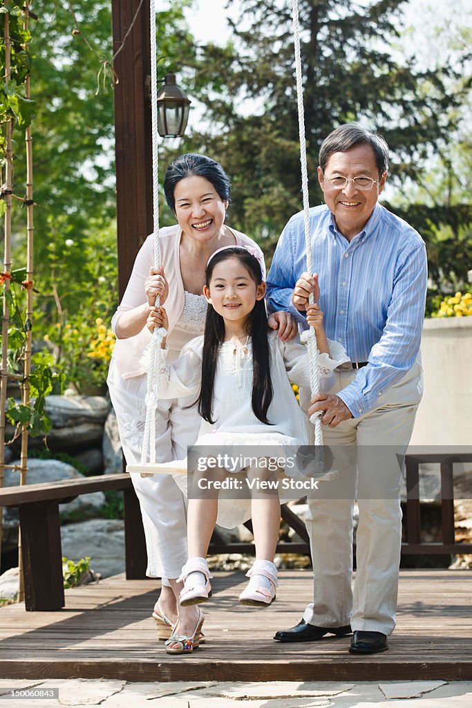 Girl playing with her grandparents