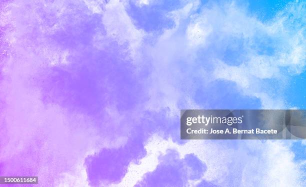 full frame of multiple blue and purple smoke explosions on a white background. - spark creativity stock pictures, royalty-free photos & images