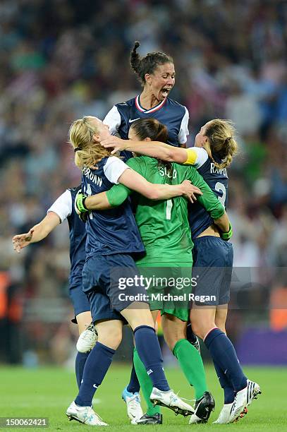 Hope Solo, Shannon Boxx and Christie Rampone of the United States celebrates after defeating Japan by a score of 2-1 to win the Women's Football gold...